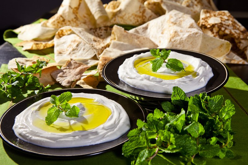 Traditional school lunch in Beirut, featuring Zaatar pizza and Labneh sandwiches in a nostalgic classroom setting.