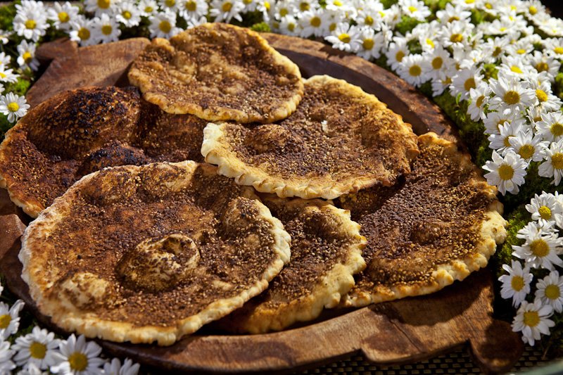 Traditional school lunch in Beirut, featuring Zaatar pizza and Labneh sandwiches in a nostalgic classroom setting.